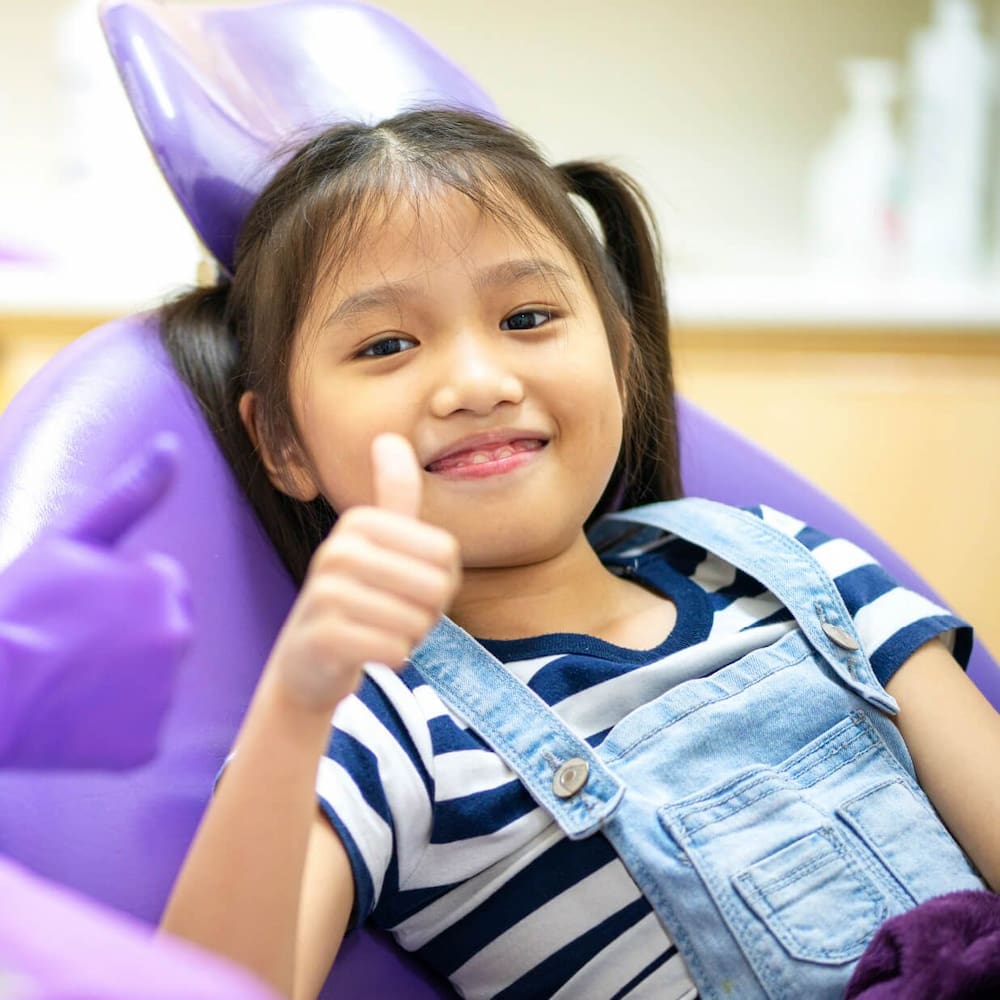 https://kokuasmiles.tradebuilderinc.comgirl during her visit to a pediatric dentist, emphasizing dental care for children | Kokua Smile